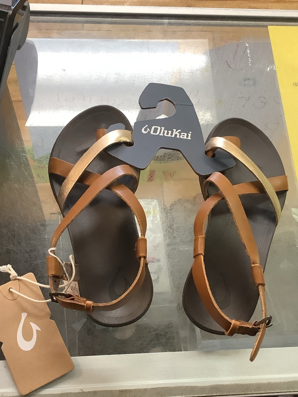 OluKai Womenโs Brown and Gold Leather Strappy Sandals